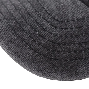 Detailed close-up of parallel stitching on washed cotton baseball cap visor