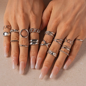 15-piece minimalist silver geometric irregular open rings set for women on stone background