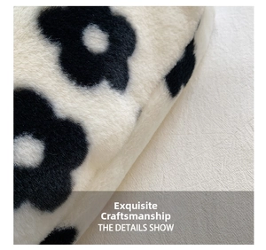 Macro shot of fluffy black and white floral plush fabric with detailed furry texture