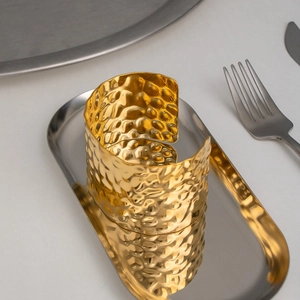 Modern hammered 18K gold-plated stainless steel wide cuff bracelet in a tray