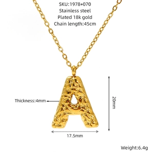 Detailed view of gold plated stainless steel lava letter A necklace with specs