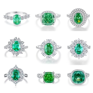 Macro display of nine S925 sterling silver rings with emerald green radiant cut zircons