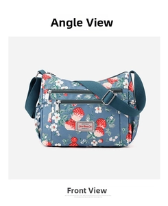 Detailed front view of gray-blue crossbody bag with strawberry and daisy floral print