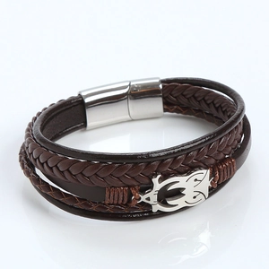 Macro detail of dark brown multilayer leather braid and polished silver magnetic buckle