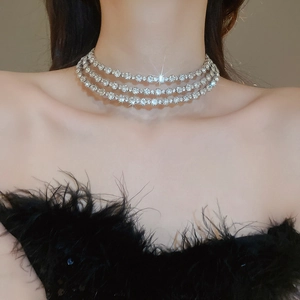 Detailed close-up of a three-row sparkling rhinestone choker on a model neckline
