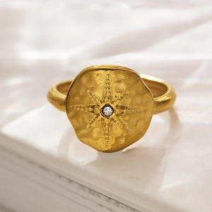 Adjustable 18k gold plated stainless steel ring featuring a starburst crystal and hammered texture