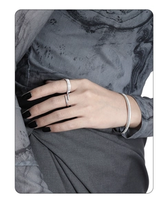 Detail shot of silver S925 open ring and bracelet set with vertical stripe texture