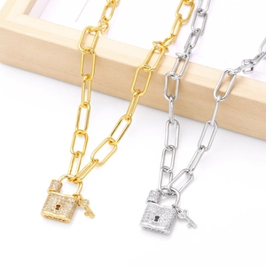 Gold and silver paperclip link necklaces with zircon-studded lock and key pendants