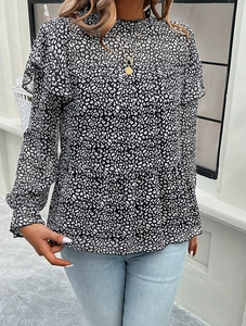 Detail of high neck floral blouse with ruffled edges and leopard print pattern