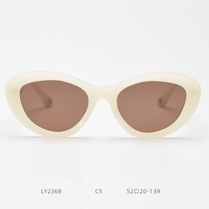 Detailed view of cream cat-eye sunglasses with brown lenses and frame size specs