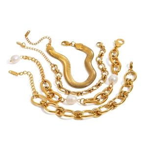 Set of four gold stainless steel bracelets featuring snake chains and white pearls