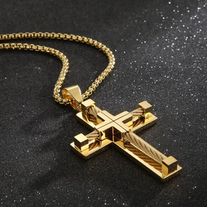 Macro view of golden double-layer cross pendant with metal wire wrapping details
