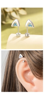 Detailed close-up of cat ear cartilage studs with blue zircon and screw back closure