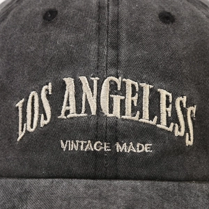 Close-up of Los Angeles vintage embroidery on a washed cotton baseball cap texture