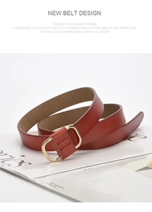 Detail of a brown leather belt with a golden D-ring buckle and fine stitching on a magazine