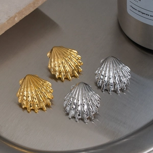 Elegant gold and silver shell stud earrings set with luxury metallic ocean style texture