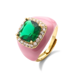 Detail of emerald-cut green stone ring with pink enamel and sparkling zircon pavé