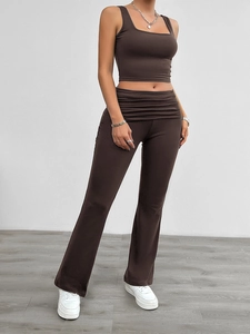 Detail of dark brown two-piece set featuring square neck crop top and flared high-waist pants