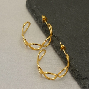 Chic gold-tone hollow hoop earrings featuring textured circular interlocking metal links