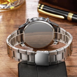 Detailed view of silver stainless steel watch strap and safety buckle on wood background