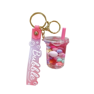 Pink bubble tea cup keychain with liquid quicksand, colorful beads and silicone strap