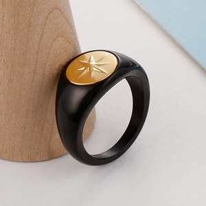 Detail of vintage heart ring with star pattern on a wooden cone display stand