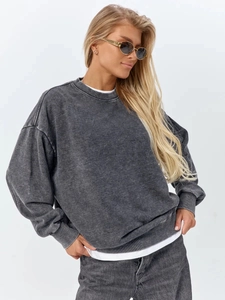 Detailed macro view of heavy acid wash cotton texture on a vintage grey sweatshirt