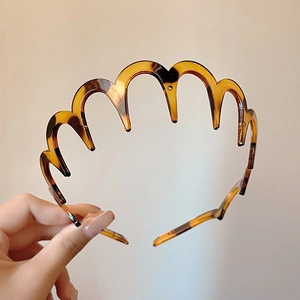 Detailed view of leopard print wavy headband with teeth for hair styling and grip