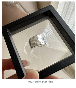 Detailed view of S925 silver wide star ring displayed in a black floating jewelry box
