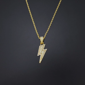 Close-up of hip hop lightning pendant with gold rope chain and pavé set diamonds