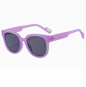 Detail view of purple frosted round frame sunglasses with dark lenses and geometric temple tips