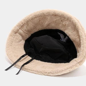 Warm beige plush bucket hat with faux rabbit fur texture and adjustable drawstring