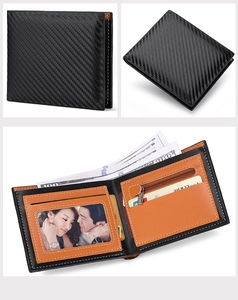 Detail view of carbon fiber wallet showing interior leather slots and zipper coin pocket