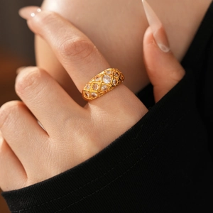 Detail of 24k gold-plated flower ring featuring hollow lattice design and zircon stones