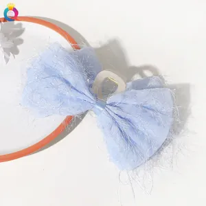 Detail of light blue chiffon bow hair claw clip with a resin base on white background