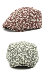 Detail of retro beret hats with abstract leaf texture in reddish brown and dark grey colors