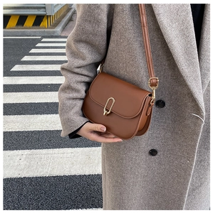 Chic brown PU leather crossbody bag with a gold U-shaped metal buckle and slim shoulder strap
