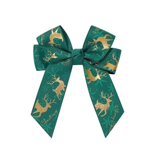 Detail of green grosgrain ribbon bow with golden reindeer and Merry Christmas print