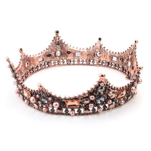 Close-up of baroque bridal crown with antique bronze metalwork and colorful gemstones