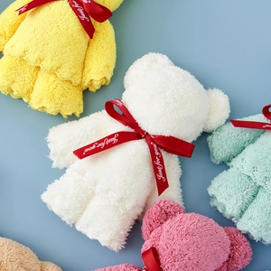 Assorted colorful coral fleece towels folded into bear shapes with Just for you ribbons