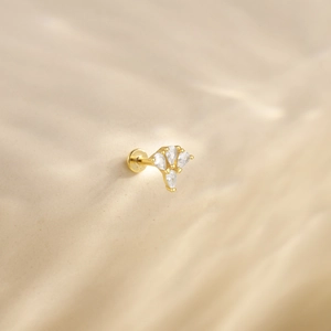Detail of 925 silver gold earring with pear-shaped cubic zirconia and flat back design
