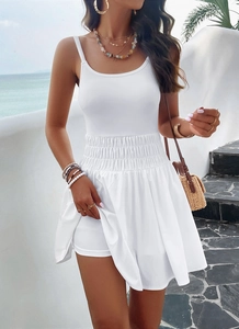 Detail view of white ribbed camisole top and pleated skirt with inner safety shorts