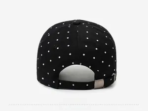 Rear view of vintage black cotton baseball cap with white dots and metal buckle