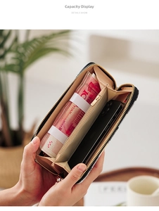 Interior detail of a long zipper wallet showing spacious compartments for cash and phone