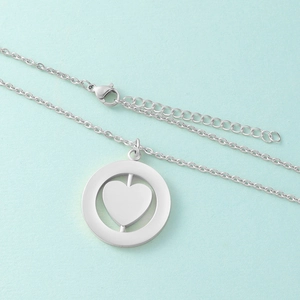 Detail of silver stainless steel rotating heart pendant with lobster clasp and chain