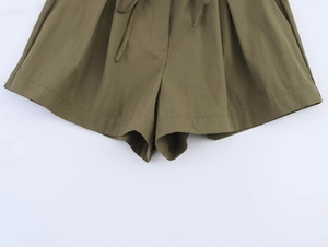 Detail view of olive green casual shorts featuring drawstring waist and premium cotton texture