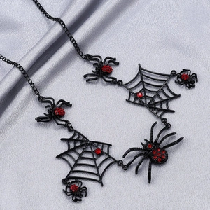 Gothic black spider web choker necklace with red rhinestones on grey silk background
