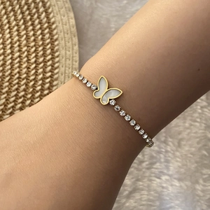 Elegant gold butterfly bracelet with white shell flower and sparkling crystals on wrist
