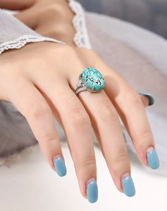 Macro view of S925 silver ring setting with turquoise stone on female hand