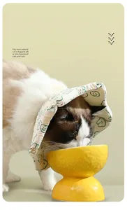 Adjustable pet recovery collar for cats eating comfortably from a yellow bowl